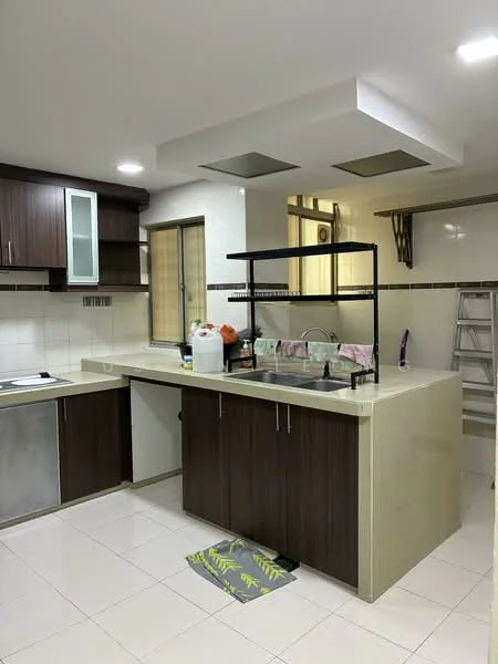Kitchen features: brown wooden cabinetry, light-colored countertop, stainless-steel sink, chrome faucet, built-in stove, tile backsplash, white tiled walls, white tiled flooring, recessed ceiling lights, window for natural light, open shelving, kitchen island with seating, ladder in background; style: modern.