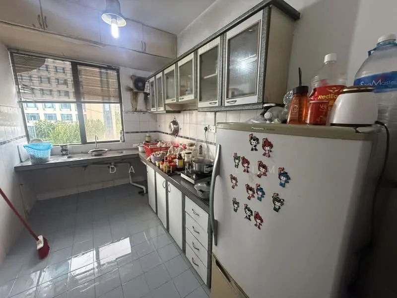 Kitchen features: white cabinets with glass doors, grey countertop, stainless-steel fridge, built-in stove, wall-mounted hood, ceramic tile flooring, window with blinds, sink with faucet, various kitchen appliances, decorative magnets on fridge, cleaning supplies, open shelving, broom in corner; view: garden.