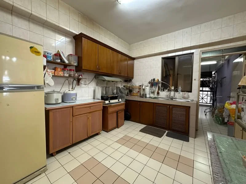 Kitchen features: cream tiled walls, white ceiling, brown wooden cabinetry, grey countertop, double-bowl stainless-steel sink, chrome pull-down faucet, freestanding refrigerator in cream, built-in oven, microwave, tile flooring, window with metal grille, kitchen utensils on countertop, open shelving, wall-mounted cabinets; style: traditional.