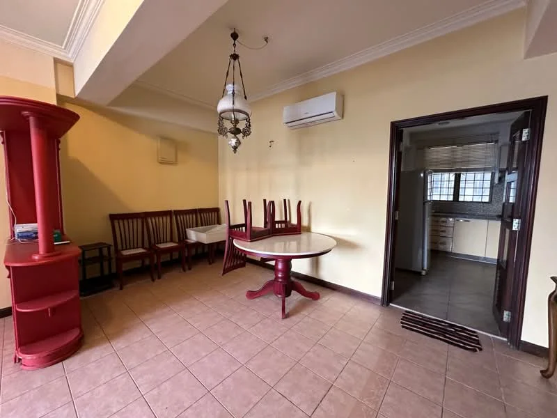 Dining features: round dining table with red base, 6 wooden dining chairs, ceiling light fixture with chandelier, wall-mounted air conditioning unit, cream painted walls, tile flooring, doorway leading to kitchen, decorative wall panel, open space layout. Kitchen features: kitchen area visible through doorway, countertop, cabinets, window for natural light.