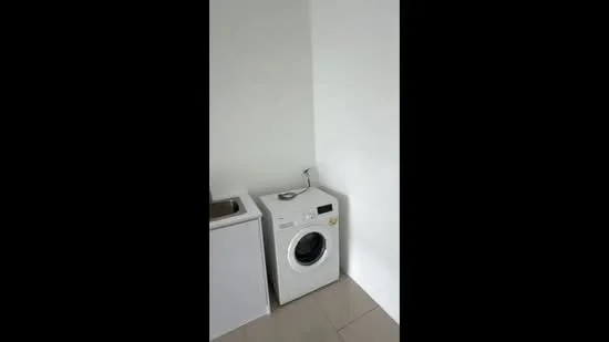 Laundry features: front-load washing machine in white, white cabinetry, grey tiled flooring, white painted walls, sink with faucet; style: modern.