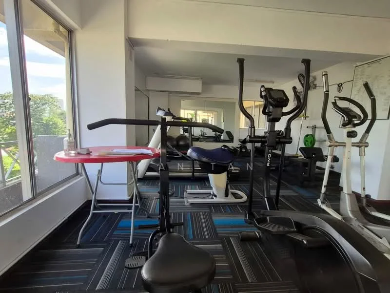 Room features: large windows providing natural light, exercise bike, elliptical machine, treadmill, weight machine, black and blue patterned flooring, small red table, exercise mat, mirrored wall, air conditioning unit; style: modern; view: garden.