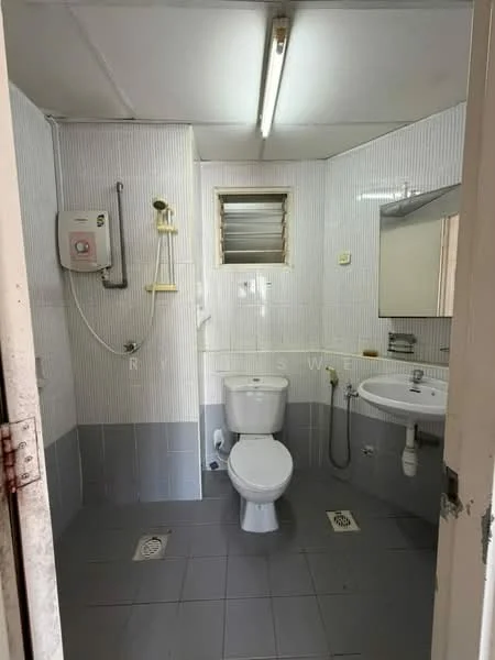 Bathroom features: white tiled walls, grey tiled flooring, one-piece toilet, single-sink vanity with mirror, chrome basin mixer faucet, shower head with wall mount, window for natural light, ceiling-mounted fluorescent lighting, electric water heater, wall-mounted soap dispenser.