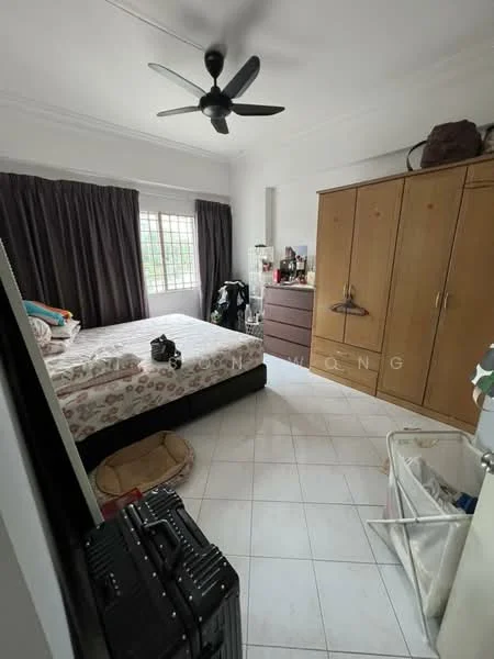 Bedroom features: queen-size bed with patterned bedding, black upholstered bed frame, wooden wardrobe with multiple doors, brown chest of drawers, white tiled flooring, ceiling fan, dark curtains, window with grid pattern, laundry basket, suitcase, decorative items on dresser.