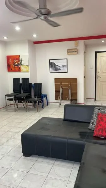 Living features: black leather sectional sofa, red decorative pillows, white tiled flooring, recessed LED downlights, 5-blade ceiling fan, framed artwork on wall, wall-mounted air conditioning unit, folding table against wall, stacked black dining chairs, white painted walls, red accent wall; style: modern.