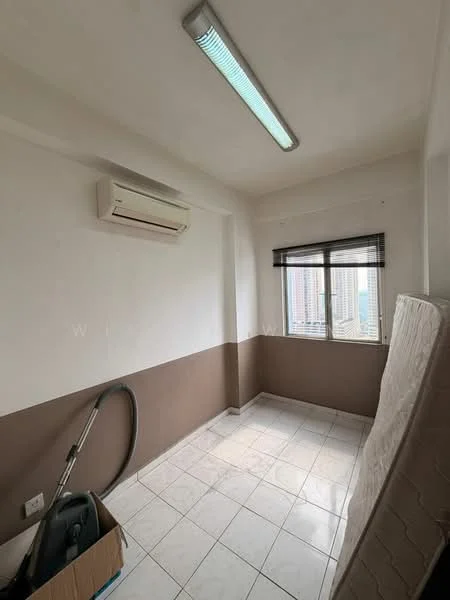 Room features: white painted walls, brown accent wall, tile flooring, window with city view, roller blinds, 1 wall-mounted split AC, fluorescent ceiling light, vacuum cleaner, mattress, cardboard box; view: city.