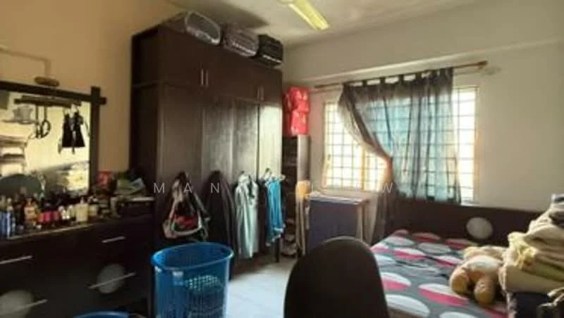 Bedroom features: wooden flooring, cream painted walls, single bed with patterned bedding, built-in wardrobe with sliding doors, window with sheer curtains, desk chair, laundry basket, decorative pillows, mirror on dresser, clothes hanging on hooks, clothing on shelves.