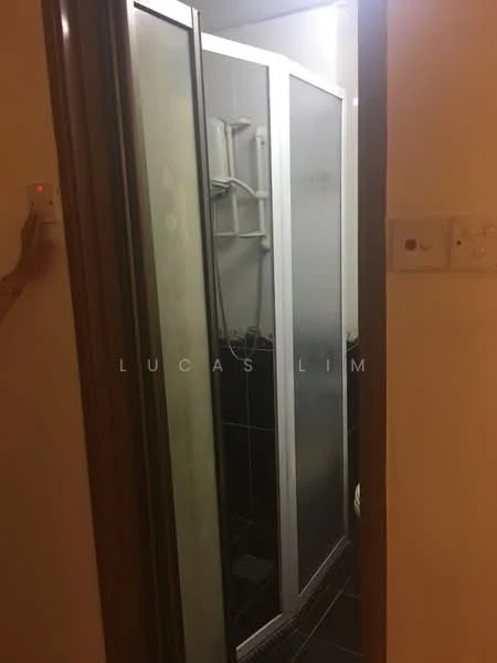 Bathroom features: glass shower enclosure, shower head, black tiled flooring, white toilet, white wall, light switch, wall-mounted shower controls, frosted glass panels.
