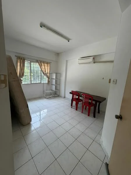 Room features: white painted walls, white tiled flooring, 1 wall-mounted split AC, window with sheer curtains, 2 red plastic chairs, wooden dining table, bookshelf, mattress leaning against the wall, ceiling light fixture.