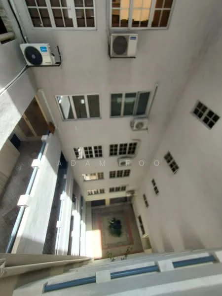 Room features: multiple windows, air conditioning units, exposed concrete walls, tile flooring, indoor garden area, decorative floor tiles, natural light from upper floors; style: modern; view: courtyard.