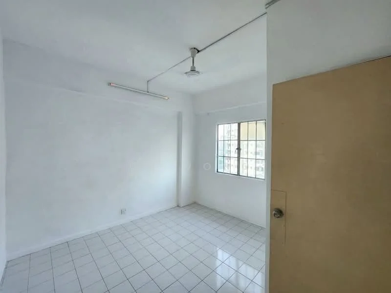 Room features: white painted walls, white tiled flooring, single ceiling light fixture, window with metal grille, door with knob, no visible furniture or decor; style: minimalist; view: city.