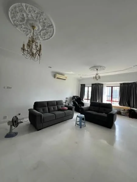 Living features: white painted walls, marble flooring, tray ceiling with decorative moulding, chandelier, 2-seater fabric sofa in grey, 3-seater fabric sofa in grey, floor-to-ceiling windows with black curtains, wall-mounted split AC, small blue stool, fan, decorative ceiling rose; style: modern.