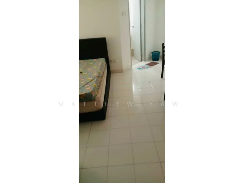 Room features: tiled flooring, single bed frame, mattress with colorful bedding, white walls, doorway leading to another room, plastic bucket, area rug, chair.