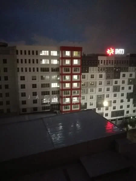 Exterior features: multi-storey building, glass windows, illuminated windows, red accent on facade, flat roof, nighttime lighting, surrounding buildings; style: modern.