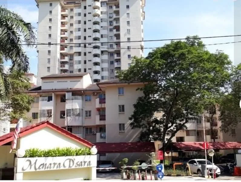 Exterior type: high-rise condominium; features: white painted facade, balconies on upper floors, landscaped entrance with greenery, red tiled roof, multiple storeys, surrounded by palm trees, visible parking area, security gate at entrance; style: modern.