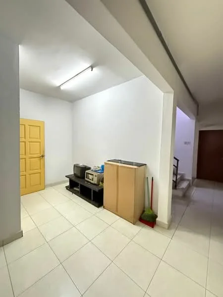 Room features: white painted walls, tile flooring, fluorescent ceiling lights, yellow door, black storage unit, wooden cabinet, cleaning tools (broom and dustpan), staircase visible in background.