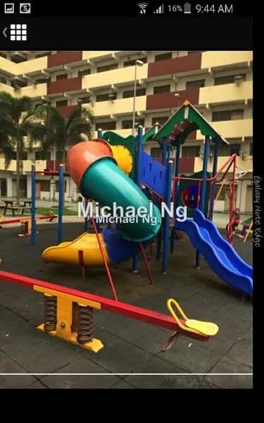 Exterior type: children's playground; features: colorful play structure, slide, tunnel, swing set, spring rider, safety flooring, surrounding palm trees, benches, open space; style: modern.