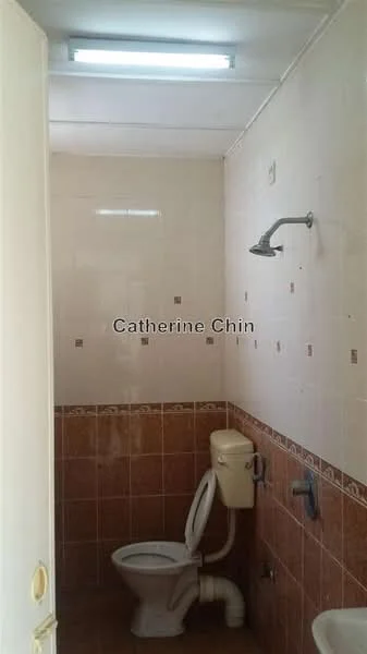 Bathroom features: white tiled walls, brown tiled flooring, shower head, toilet, wall-mounted faucet, mirror, light fixture, towel rail.