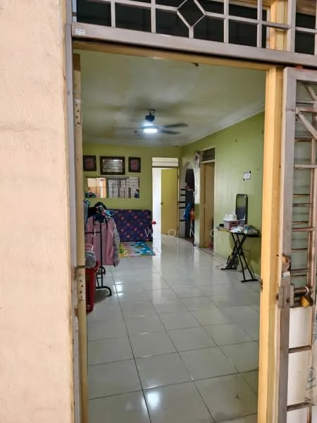 Room features: cream painted walls, white tiled flooring, ceiling fan, recessed ceiling lights, doorway with metal grille, open layout, decorative wall art, multicolored area rug, folding table, clothes rack, wooden door frame.