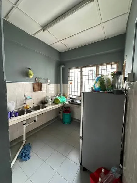 Kitchen features: single-bowl stainless-steel sink, chrome pull-down faucet, white tiled backsplash, laminate countertop, white cabinetry, built-in gas stove, refrigerator, window with grid pattern, grey painted walls, tile flooring, kitchen appliances on countertop, plastic storage containers, green gas cylinder, blender.