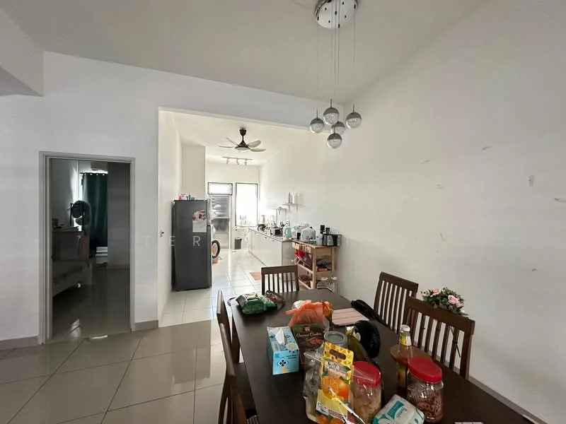 Dining features: dining table with wooden finish, 4 dining chairs, decorative flower arrangement, tile flooring, white painted walls, ceiling light fixture with multiple bulbs, open layout to kitchen, wall-mounted fan; style: modern. Kitchen features: grey fridge, white cabinetry, stainless-steel sink, countertop with appliances, tile backsplash, open layout to dining area; style: modern. Room features: bed visible in background, curtains on window, doorway leading to another room.