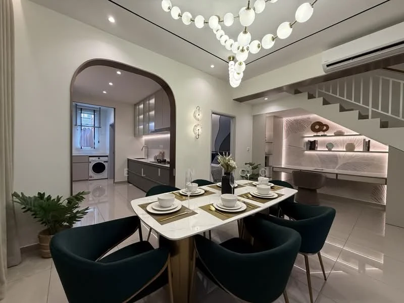 Dining features: 6-seater dining table, white tabletop, golden legs on dining table, upholstered dining chairs in dark green, decorative vase with flowers, wall-mounted lighting fixtures, pendant light with spherical bulbs, open shelving unit with decorative items, grey cabinetry in kitchen area, built-in washing machine, recessed ceiling lights, glossy tile flooring, staircase with wooden steps; style: modern.