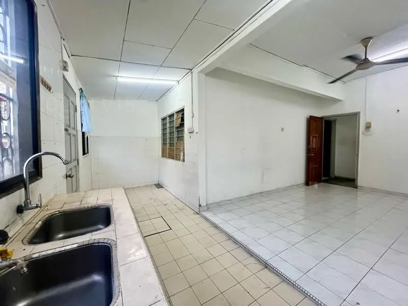Kitchen features: double-bowl stainless-steel sink, chrome pull-down faucet, white tiled backsplash, white tiled flooring, wooden cabinetry, window with sheer curtains, wall-mounted lighting, exposed ceiling, open layout to living area. Living features: white painted walls, white tiled flooring, ceiling fan, open layout, doorway leading to entrance.