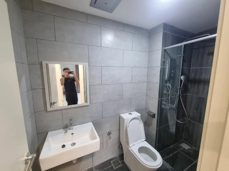 Bathroom features: grey tiled walls, black tiled flooring, single-sink vanity with wall-mounted mirror, one-piece toilet, walk-in shower with glass enclosure, rain shower head, handheld shower, chrome basin mixer, recessed ceiling lights, exhaust fan; style: modern.