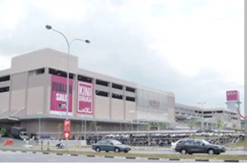 Exterior type: multi-storey car park; features: grey concrete facade, multiple levels visible, large signage for sale, open-air parking lot, surrounded by road, landscaped areas at base; style: modern.