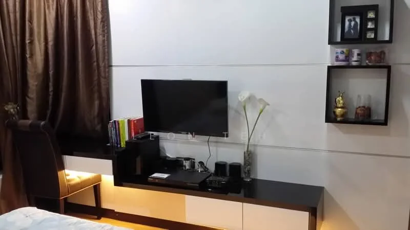 Room features: dark wood TV console, flat-screen TV, black media player, black speakers, white painted walls, brown curtains, decorative wall shelves, books on shelf, decorative figurines, white flowers in vase, soft lighting under TV console, upholstered chair; style: modern.