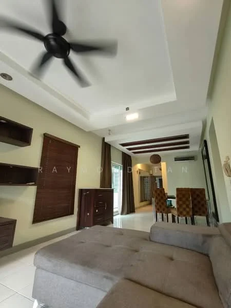 Living features: 5-blade ceiling fan with light, cream painted walls, white ceiling with recessed lighting, dark wood shelving unit, brown wooden sideboard, large window with blinds, brown curtains, grey fabric sectional sofa, tile flooring, dining area visible in background, decorative wall paneling; style: modern.