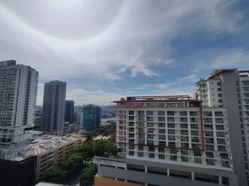 Exterior type: high-rise condominium; features: glass curtain wall, balconies with railings, surrounding urban landscape, city skyline view, multiple storeys, modern architectural design; style: modern.