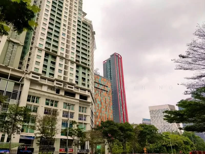 Exterior type: high-rise condominium; features: glass curtain wall, green-tinted windows, red accent facade, multiple storeys, surrounded by greenery, urban context with nearby buildings; style: modern.