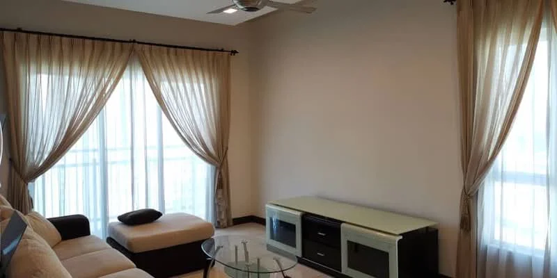 Living features: cream painted walls, white ceiling, 5-blade ceiling fan, floor-to-ceiling windows, sheer curtains, dark wood flooring, light-colored sofa, glass coffee table, TV console with storage; style: modern.