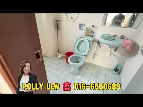 Bathroom features: white toilet, sink with chrome faucet, mirror above sink, white tiled walls, white tiled flooring, shower head on wall, toilet paper holder, cleaning supplies on sink, red bucket, hanging towel, soap dispenser.