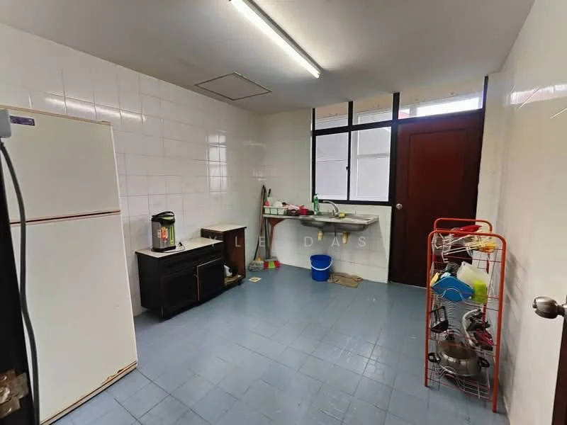 Kitchen features: white tiled walls, blue vinyl flooring, single-bowl stainless-steel sink, chrome pull-down faucet, built-in countertop, white refrigerator, black kitchen cabinet, window with natural light, open shelving, plastic bucket, metal rack with kitchen items.