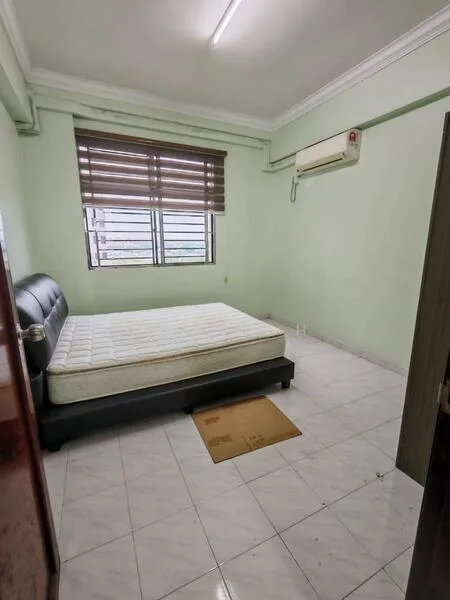 Bedroom features: single bed, white mattress, green painted walls, white tiled flooring, window with wooden blinds, wall-mounted air conditioning unit, ceiling light, door with handle.