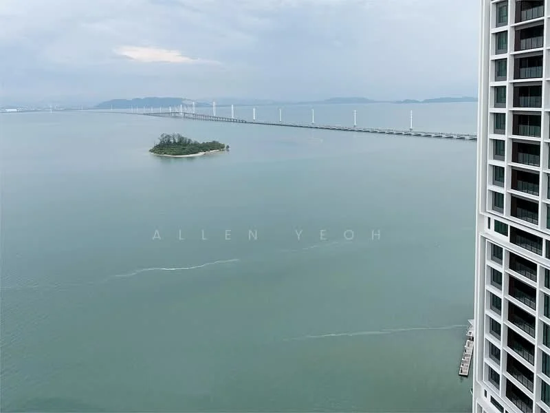 Exterior type: high-rise condominium; features: view of the sea, island in the distance, bridge visible, cloudy sky, waterfront location; style: modern.