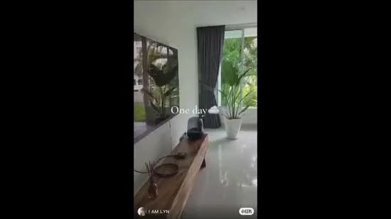 Room features: large window with view of greenery, grey curtains, wooden console table, decorative bowl on table, decorative plant in pot, white walls, glossy tile flooring, indoor plants; style: modern; view: garden.