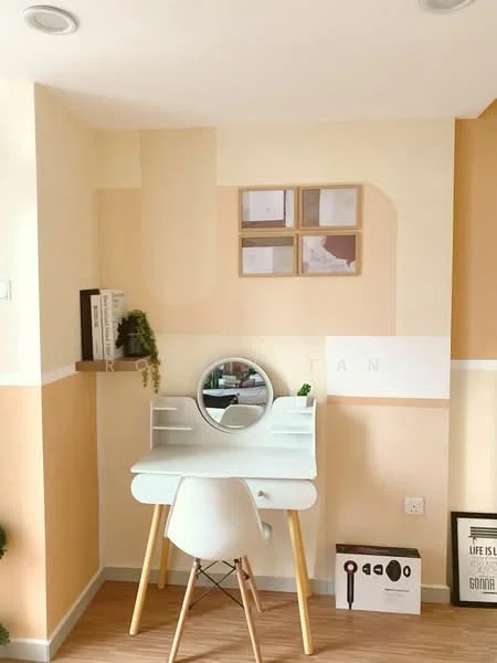 Study features: light beige painted walls, white accent wall, wooden flooring, white desk with mirror, white chair with wooden legs, framed artwork on wall, shelf with books, decorative plant, wall-mounted light fixtures, minimalist decor; style: modern.