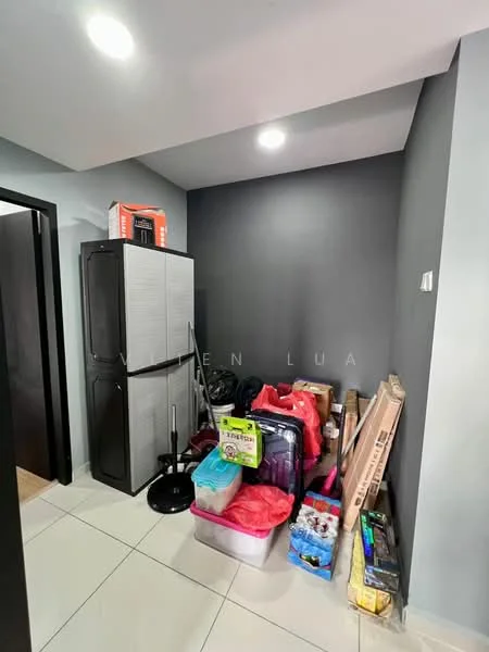 Room features: grey painted walls, white tile flooring, recessed ceiling lights, black refrigerator, various boxes and bags, plastic storage containers, cleaning supplies, cluttered space.