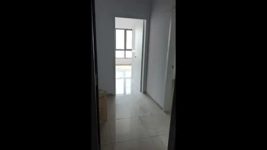 Room features: white painted walls, glossy tile flooring, floor-to-ceiling windows, doorway leading to another room, natural light from windows.