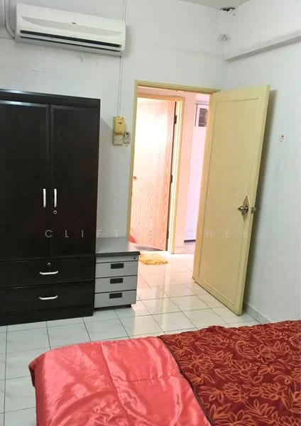 Bedroom features: queen-size bed with red floral bedding, dark wood wardrobe with sliding doors, white tiled flooring, wall-mounted split AC unit, light yellow door leading to hallway, two-drawer bedside table, decorative wall art, window with sheer curtains; style: modern.