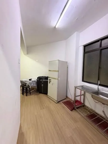 Kitchen features: white painted walls, laminate flooring, single-bowl stainless-steel sink, chrome faucet, white refrigerator, black freestanding stove, small dining table with chairs, window with black frame.