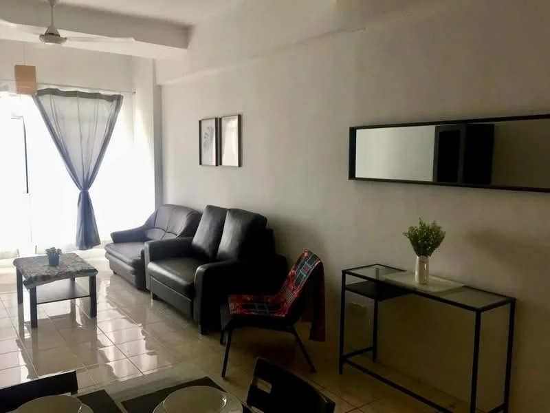 Living features: black leather sofa, glass coffee table, white walls, tile flooring, floor-to-ceiling windows, sheer curtains, decorative mirror, small potted plant, side table with decorative vase, area rug, wall art frames; style: modern.