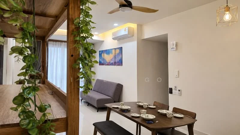 Living features: 5-blade ceiling fan with light, sofa in grey fabric, wooden dining table, 4 dining chairs, decorative wall art, white painted walls, recessed lighting, floor-to-ceiling windows with sheer curtains, light-colored flooring, greenery decor hanging from wooden structure, air conditioning unit on wall; style: modern.