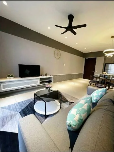 Living features: grey fabric sofa, decorative cushions in blue and green, round coffee table with black base, flat-screen TV on white console, wall-mounted clock, recessed LED downlights, ceiling fan with light, area rug with geometric pattern, dining table in background, wooden door, neutral painted walls, light-colored flooring; style: modern.