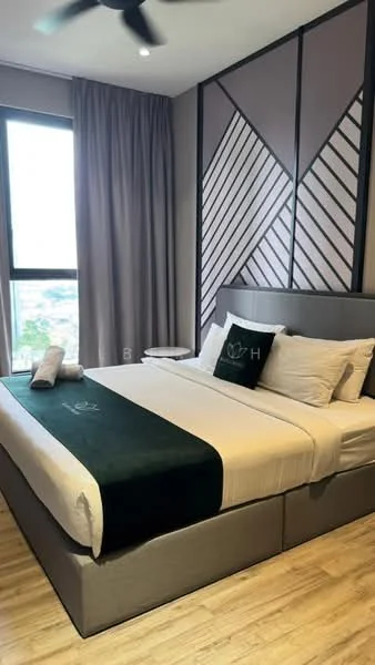 Bedroom features: king-size bed with grey upholstered headboard, white bedding with green accent throw, two white pillows, wooden flooring, floor-to-ceiling window, grey curtains, side table with lamp, decorative wall with geometric pattern, ceiling fan with light; style: modern; view: city.