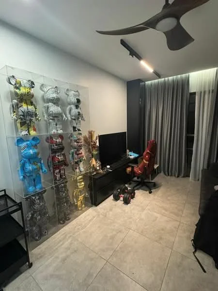 Room features: grey tiled flooring, white painted walls, 5-blade ceiling fan, floor-to-ceiling curtains, black entertainment unit, wall-mounted TV, display cabinet with collectibles, black office chair, dark sofa, decorative figurines, LED lighting, open space layout; style: modern.