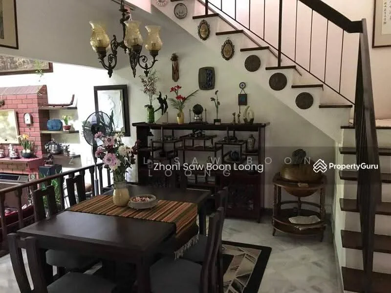 Dining features: wooden dining table, 4 wooden dining chairs, decorative table runner, ceramic plates on wall, wall-mounted decorative items, hanging chandelier with multiple bulbs, potted flowers on table, wooden sideboard, staircase in background, marble flooring, wall art, brick feature wall; style: traditional.